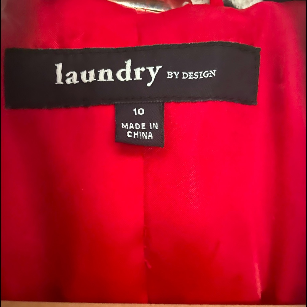 B&W multi pattern knit coat. Red satiny lining. Double breasted button closure.